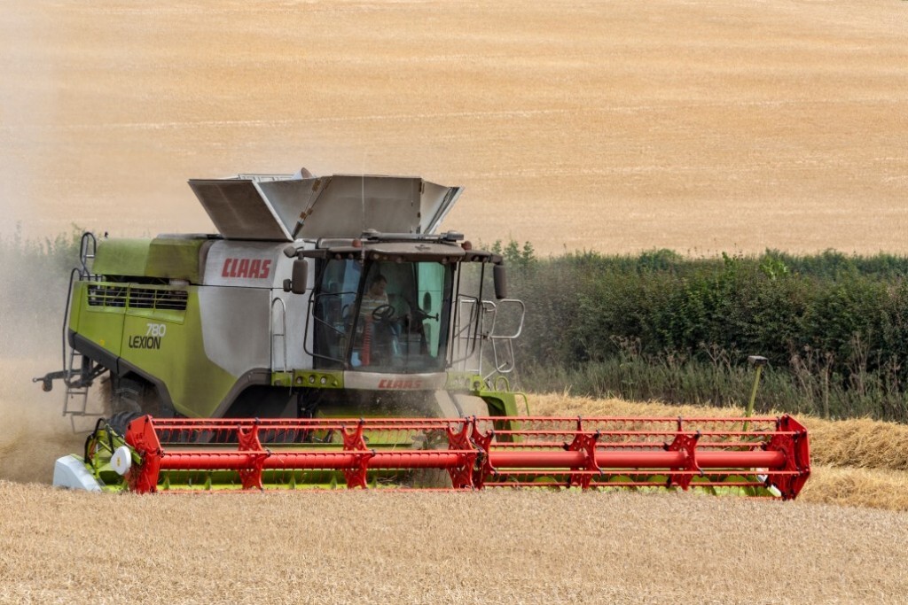 harvester-working-in-a-field-scaled